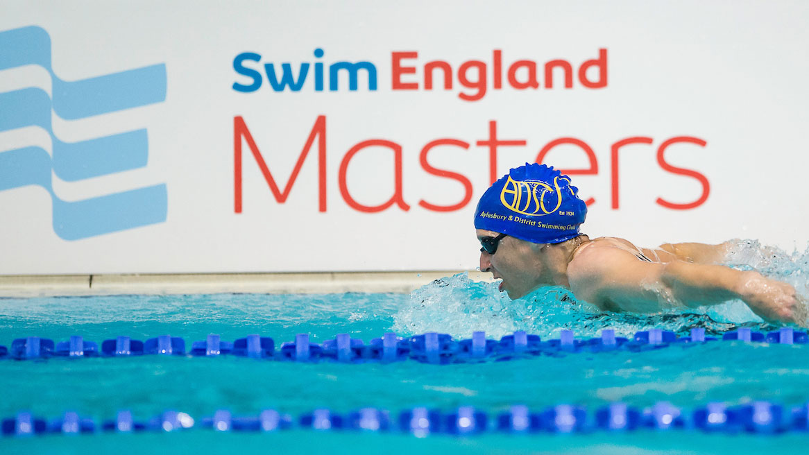 Butterfly swimmer in front of Swim England Masters branding.