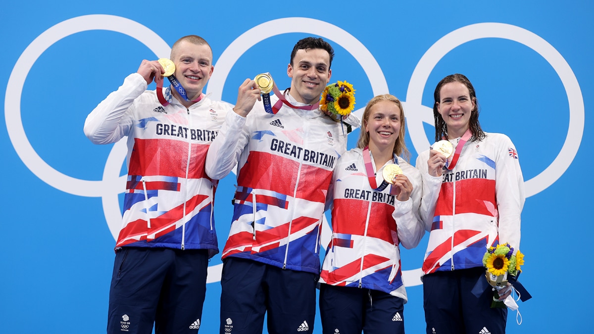 Adam Peaty, James Guy, Anna Hopkin and Kathleen Dawson with their gold medals on the Olympic podium after winning the Mixed Medley Relay in a new world record time