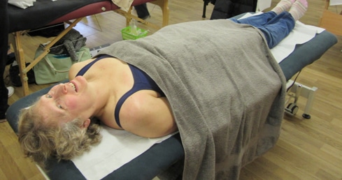 How does a sports massage help swimming recovery?