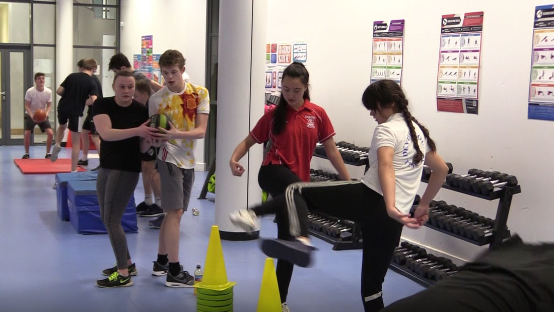 Water polo players practicing gym exercises at the 2018 National Academy training camp